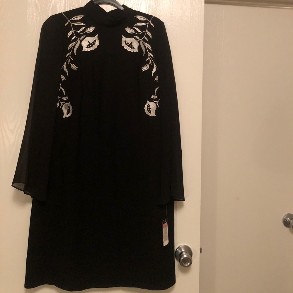 Sheer sleeved black and white appliqué dress.